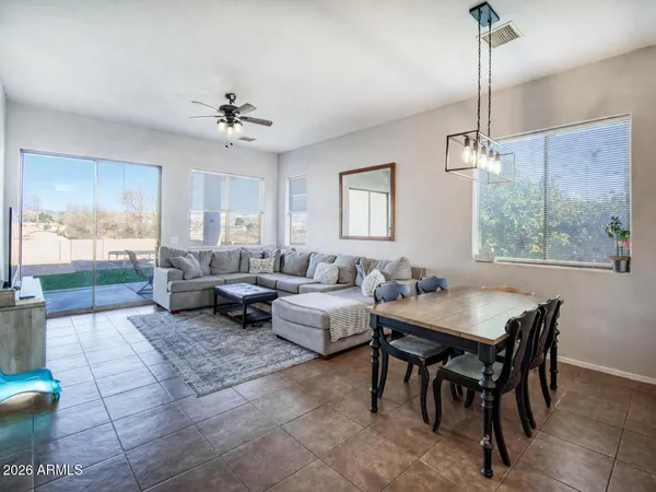 a living room with patio furniture and a floor to ceiling window