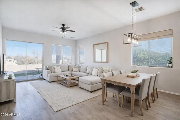 a living room with furniture and a chandelier