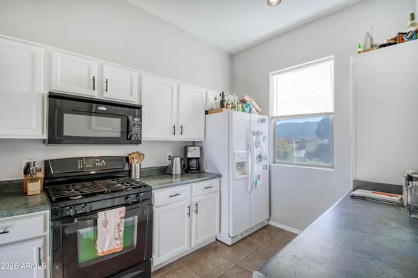 a kitchen with stainless steel appliances a stove a sink a refrigerator a window