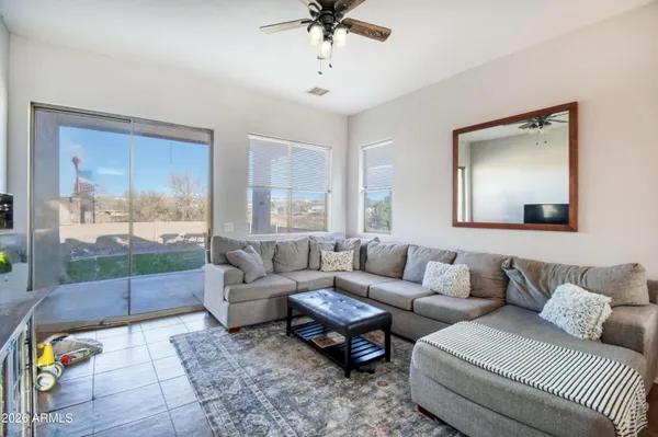 a living room with furniture and a floor to ceiling window