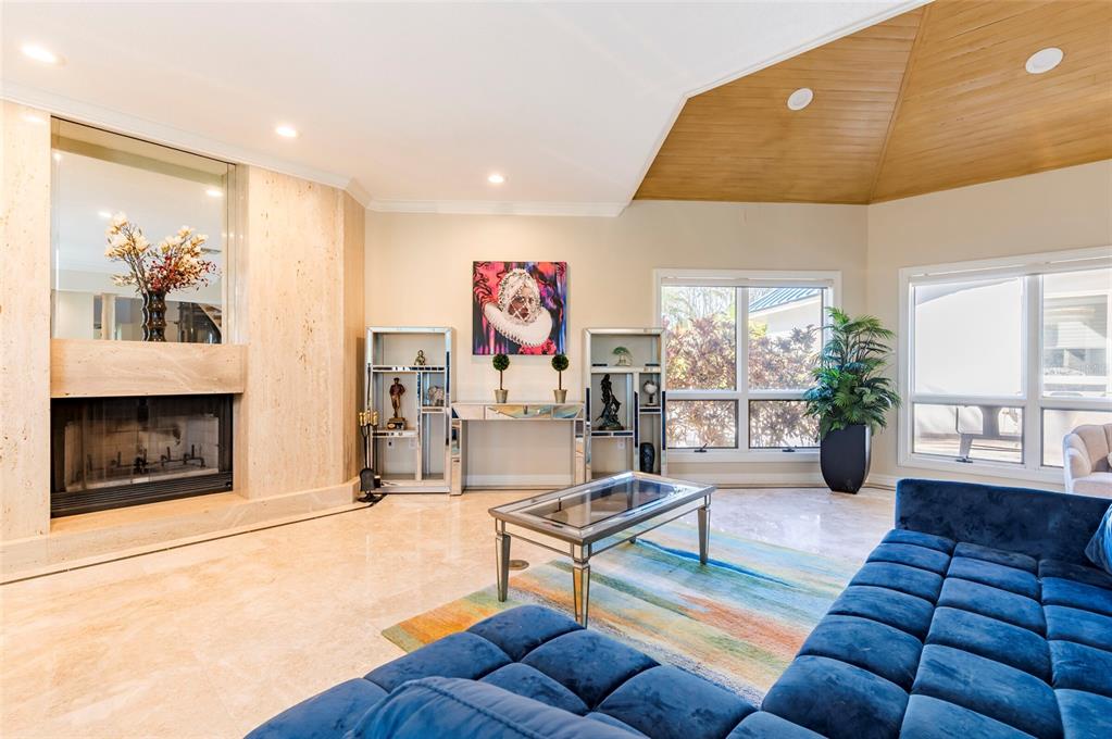 2268 Kings Point Drive Largo, FL 33774 - Photo 14 of 84 a living room with furniture a fireplace and a large window