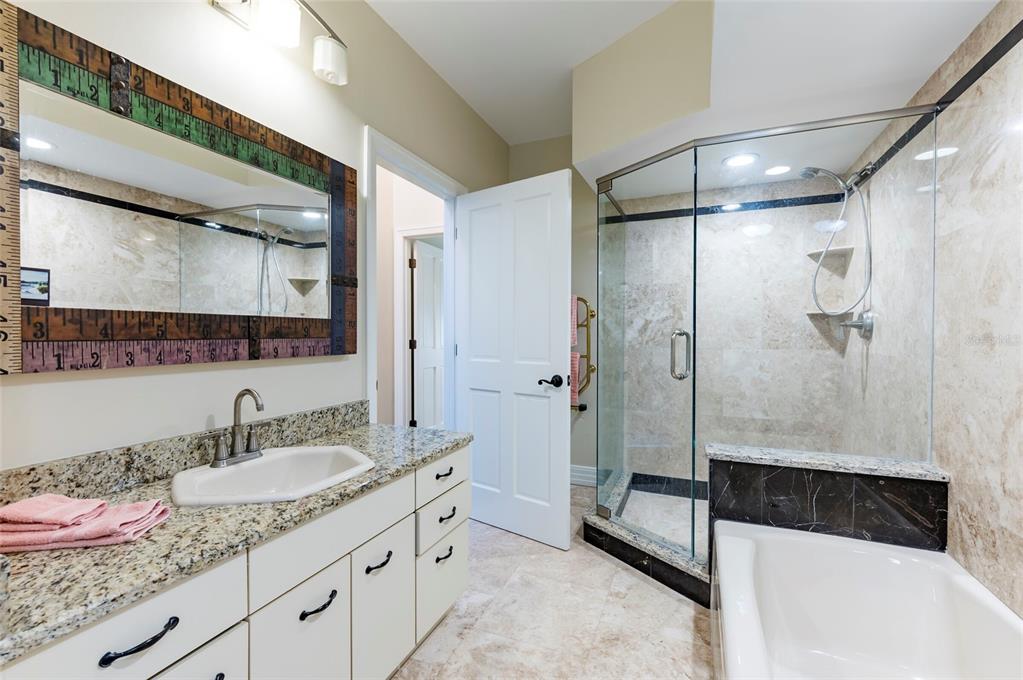 2268 Kings Point Drive Largo, FL 33774 - Photo 20 of 84 a bathroom with a granite countertop sink a shower and a mirror