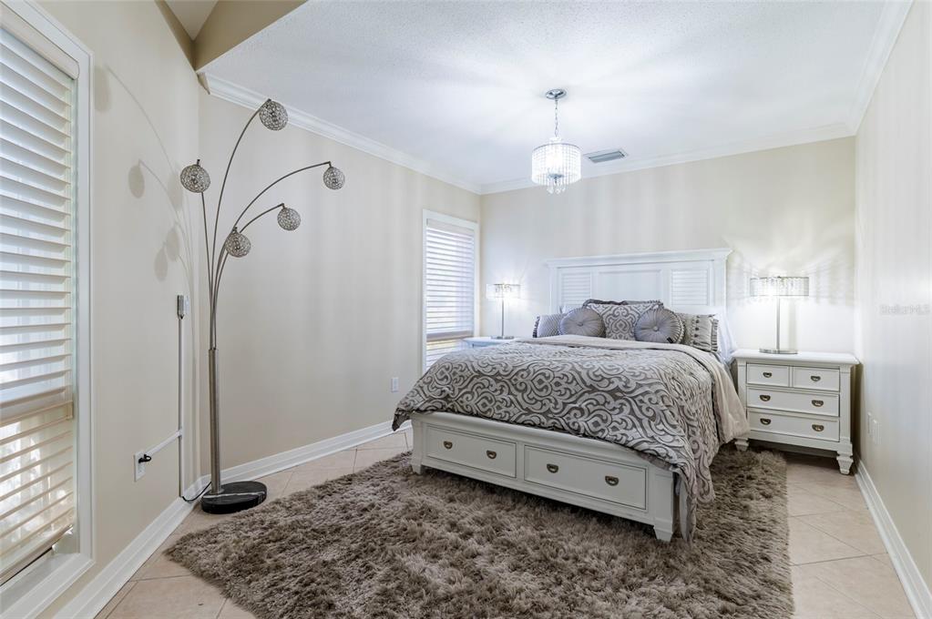2268 Kings Point Drive Largo, FL 33774 - Photo 24 of 84 a bedroom with a bed and a chandelier