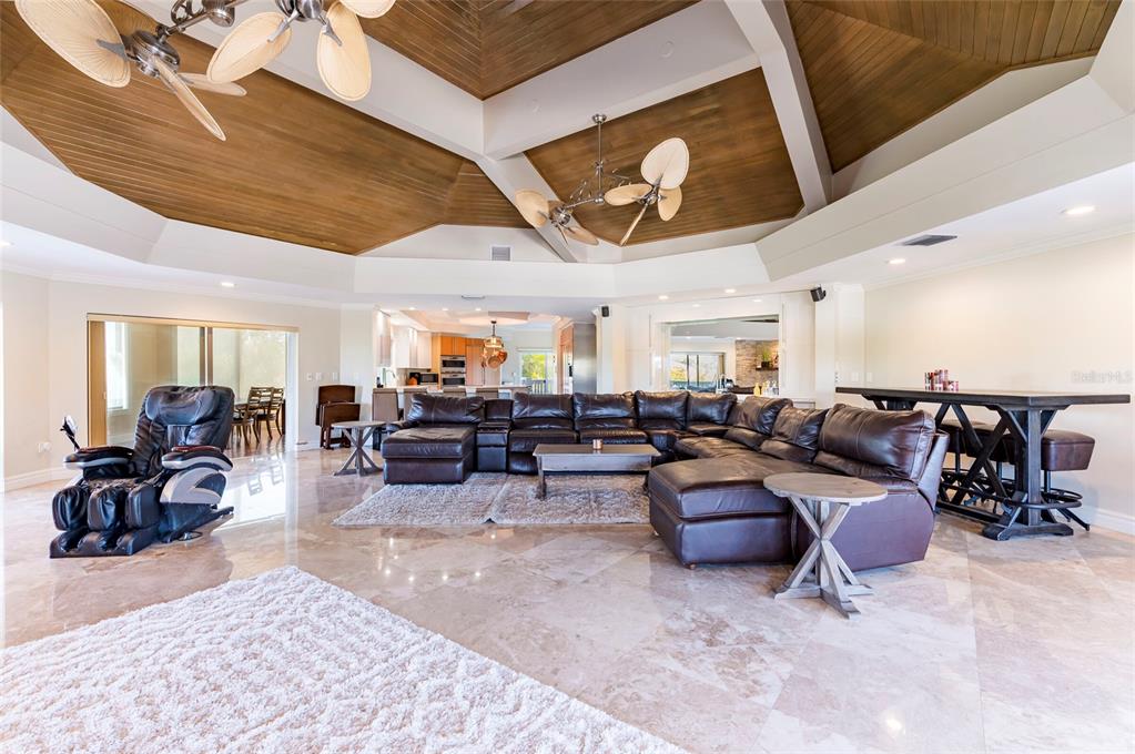 2268 Kings Point Drive Largo, FL 33774 - Photo 31 of 84 a living room with lots of furniture and paintings on the wall