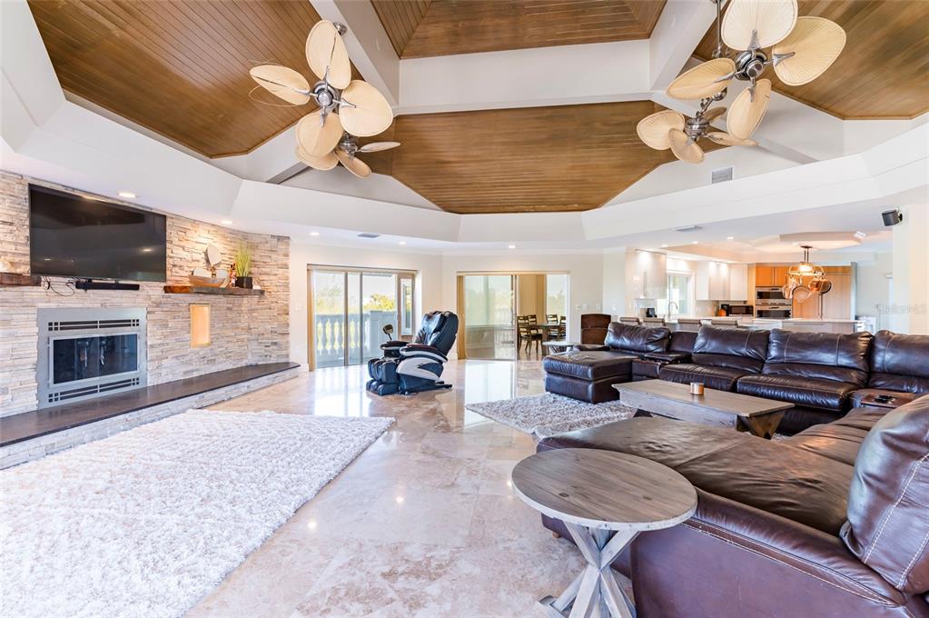 2268 Kings Point Drive Largo, FL 33774 - Photo 32 of 84 a living room with furniture a flat screen tv and kitchen view