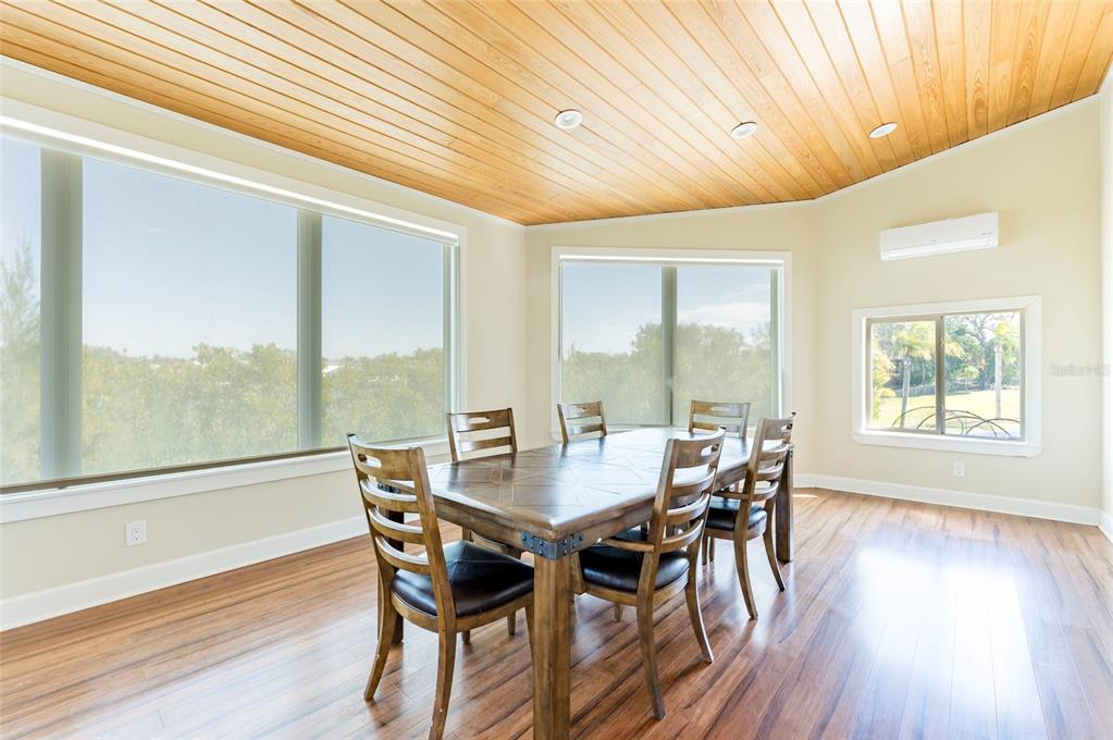 2268 Kings Point Drive Largo, FL 33774 - Photo 39 of 84 a view of a dining room with furniture window and wooden floor