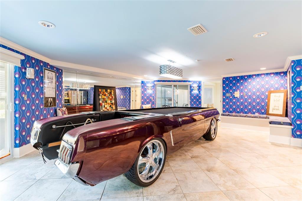 2268 Kings Point Drive Largo, FL 33774 - Photo 46 of 84 a bedroom with a bed and a chandelier