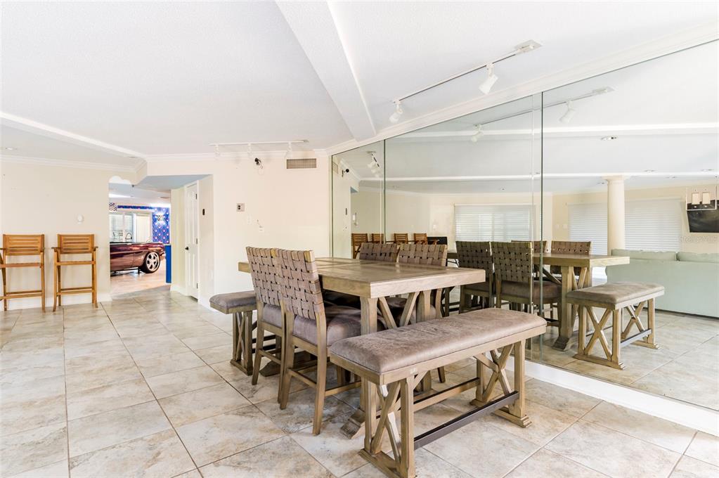 2268 Kings Point Drive Largo, FL 33774 - Photo 51 of 84 a dining room with furniture and a floor to ceiling window