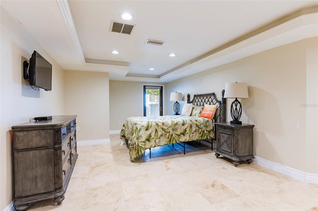 2268 Kings Point Drive Largo, FL 33774 - Photo 61 of 84 a bedroom with furniture and flat screen tv