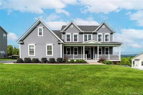 a front view of house with yard and green space