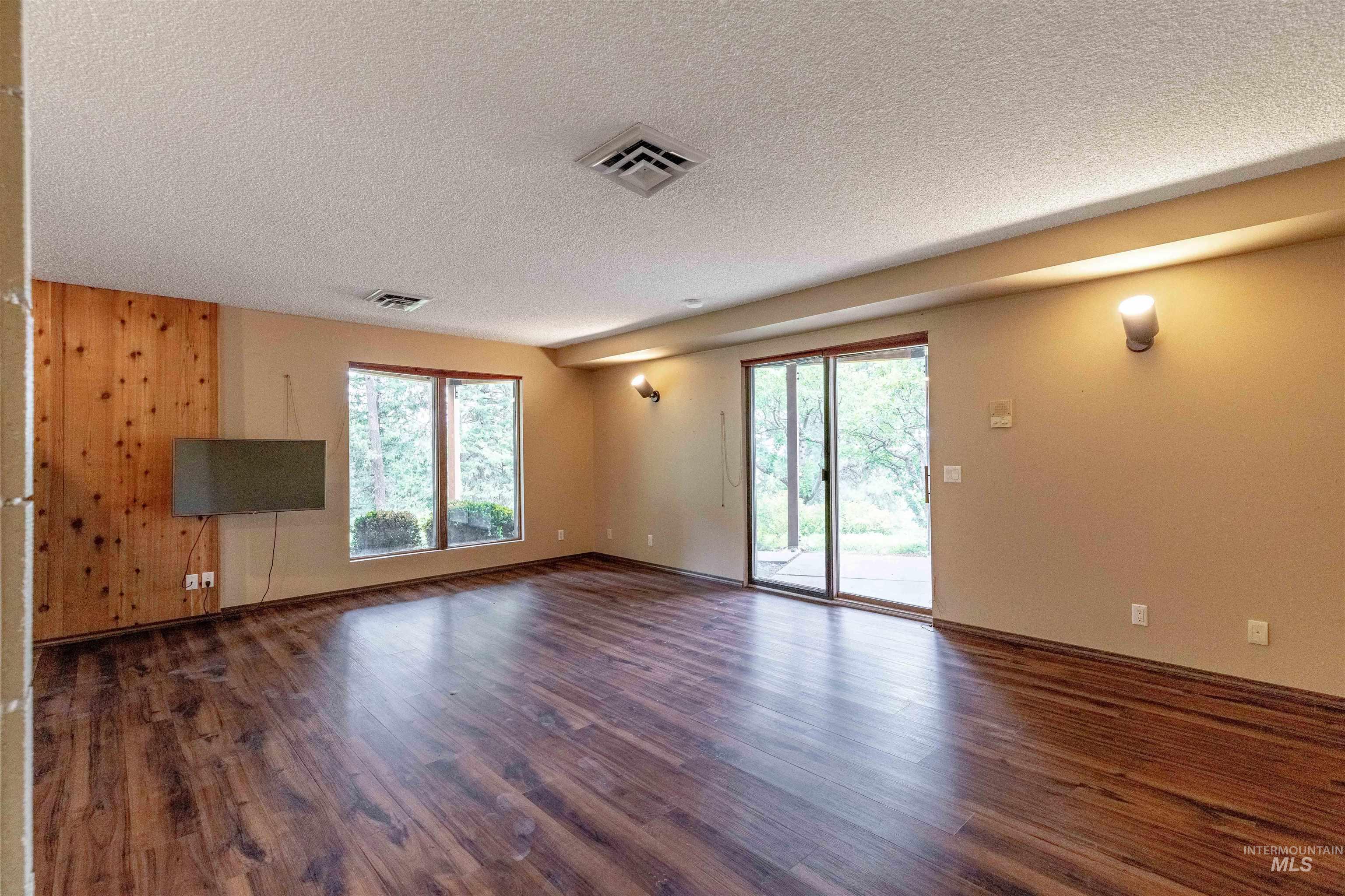 1050 Paradise Ridge Road Moscow, ID 83843 - Photo 26 of 49 Unfurnished living room with dark wood-style flooring and a textured ceiling