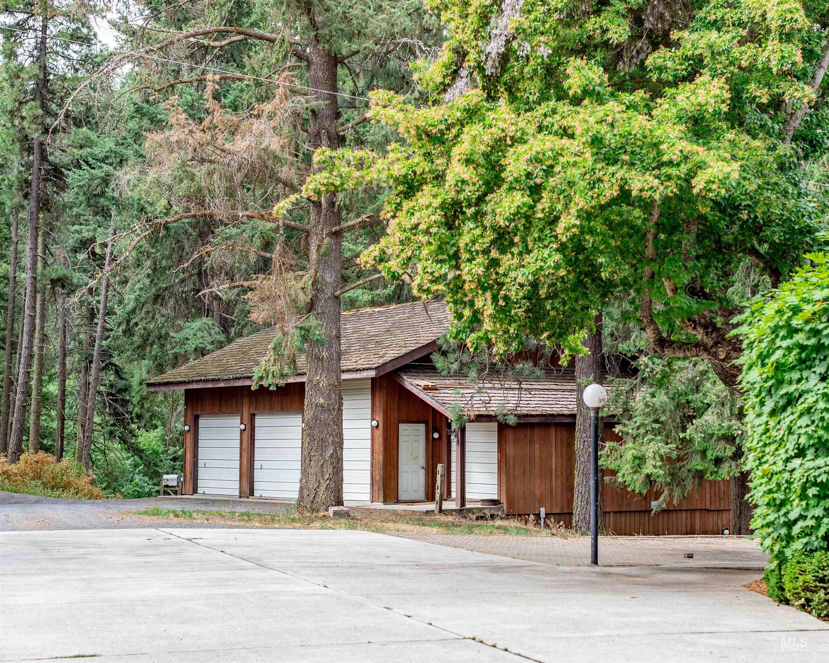 1050 Paradise Ridge Road Moscow, ID 83843 - Photo 39 of 49 Rustic home featuring a detached garage and roof with shingles