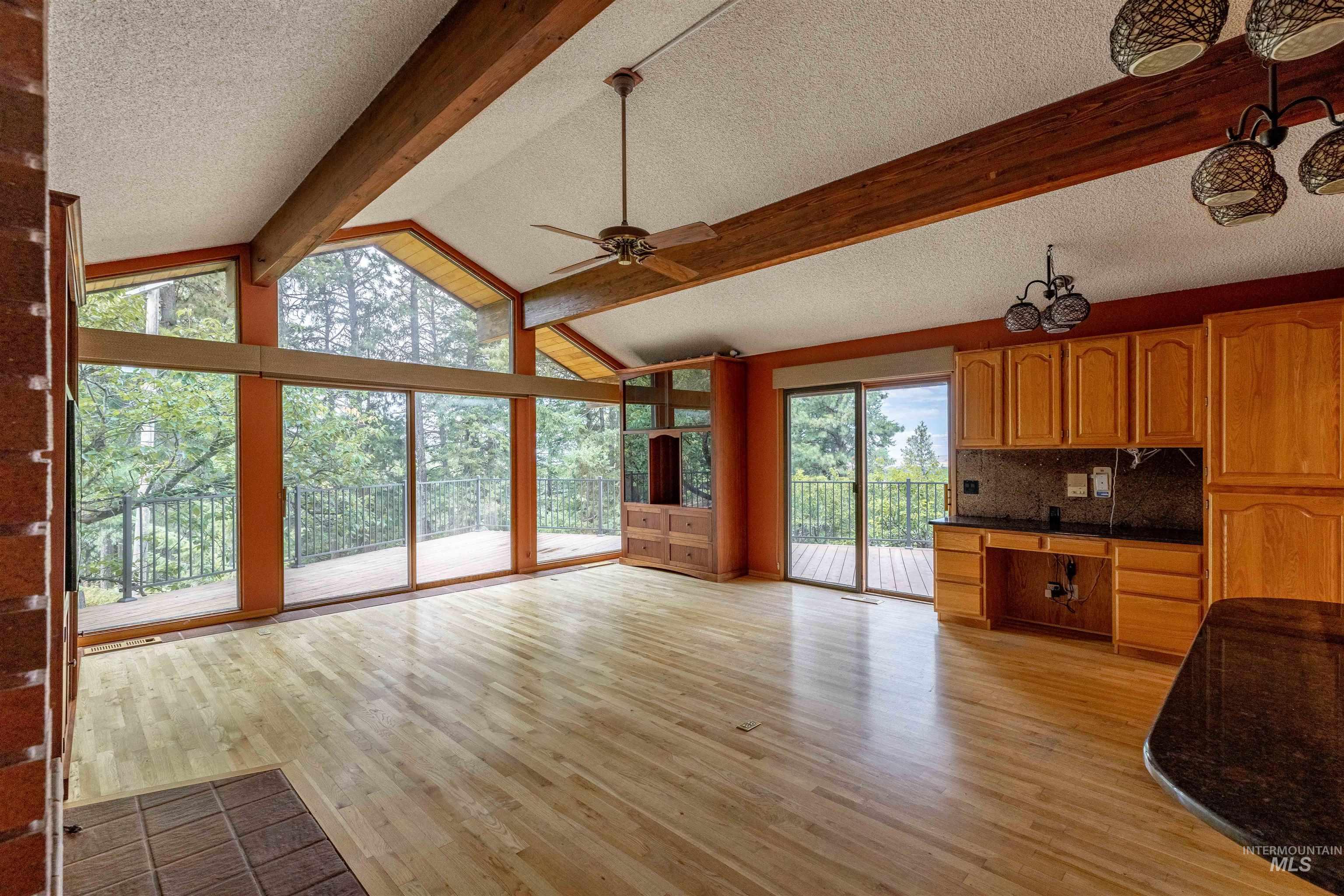 1050 Paradise Ridge Road Moscow, ID 83843 - Photo 6 of 49 Unfurnished living room featuring a textured ceiling, light wood finished floors, and ceiling fan