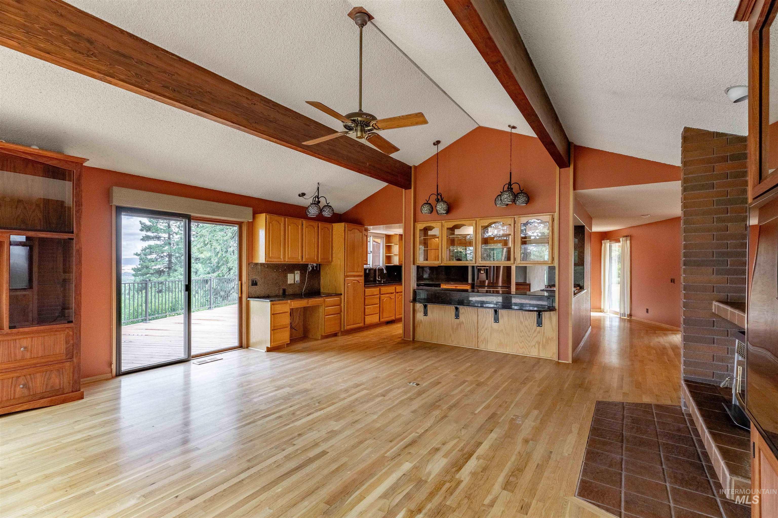 1050 Paradise Ridge Road Moscow, ID 83843 - Photo 8 of 49 Kitchen featuring glass insert cabinets, dark countertops, light wood-type flooring, a textured ceiling, and ceiling fan