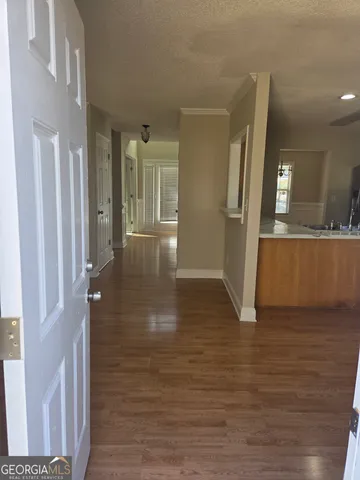 a view of a hallway view with wooden floor and staircase