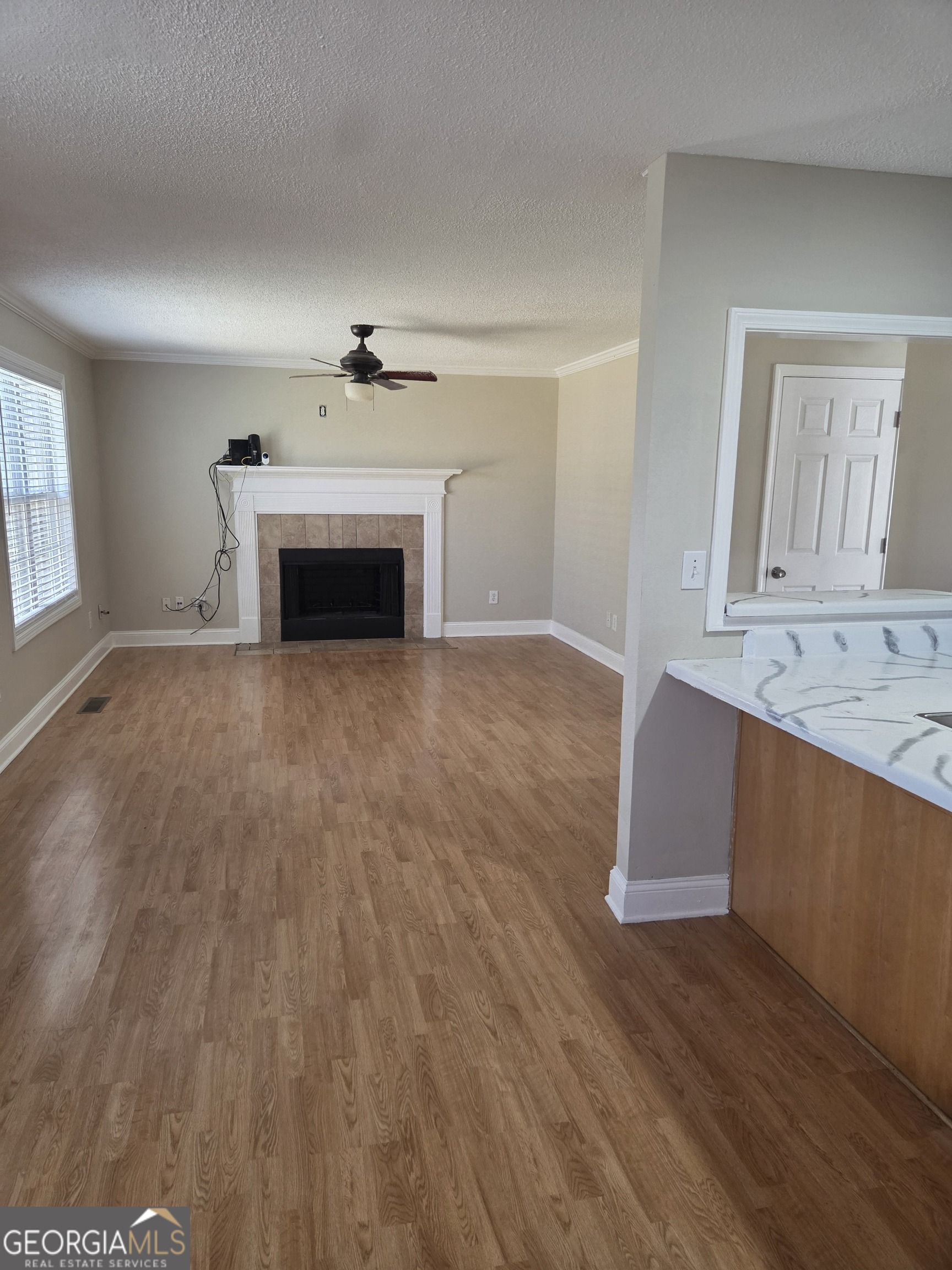 130 Stephanie Lane Covington, GA 30016 - Photo 18 of 18 wooden floor fireplace and windows in an empty room
