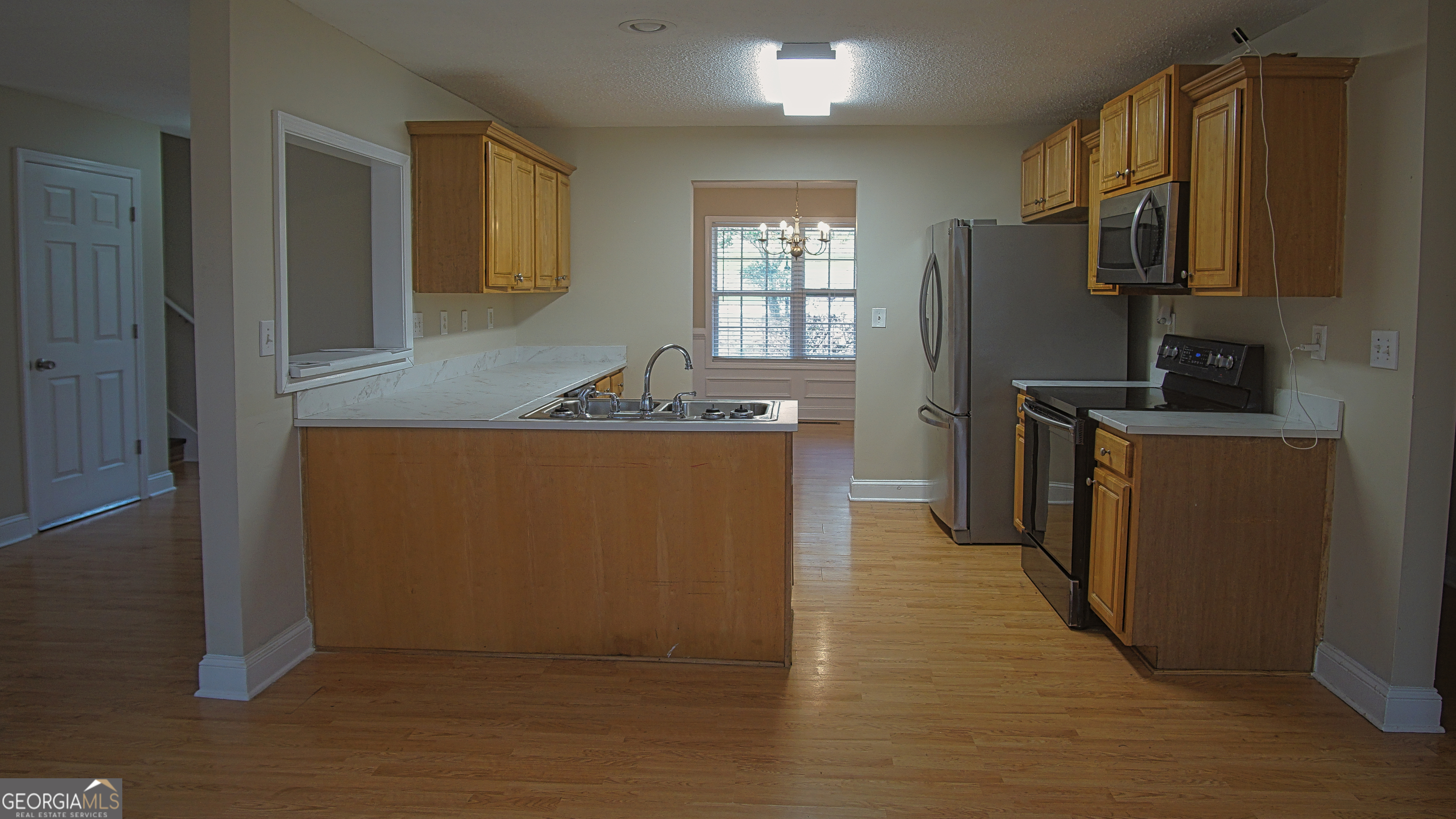 130 Stephanie Lane Covington, GA 30016 - Photo 39 of 67 a kitchen with stainless steel appliances granite countertop a sink stove and refrigerator