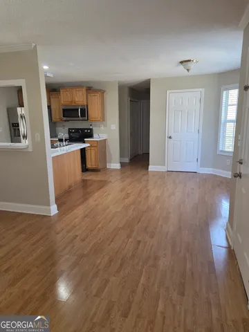a view of kitchen with sink and wooden floor