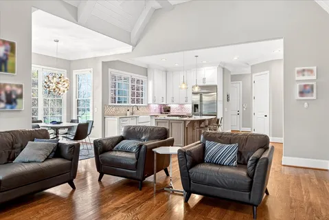 a living room with furniture wooden floor and a large window