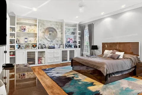 a bedroom with a large bed and a window