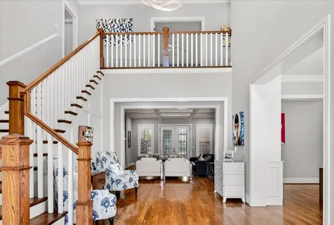 a living room with furniture or wooden floor and a large window