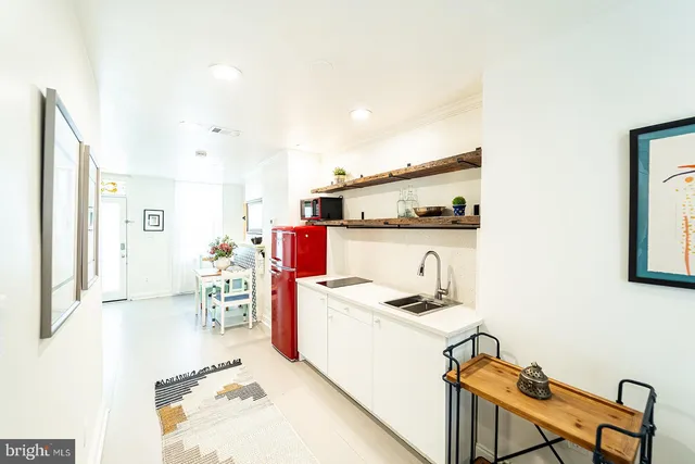 a room with furniture a flat screen tv and a refrigerator
