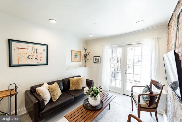 a living room with furniture rug and window