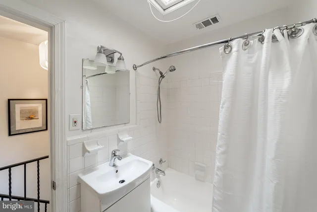 a bathroom with a shower curtain and a sink