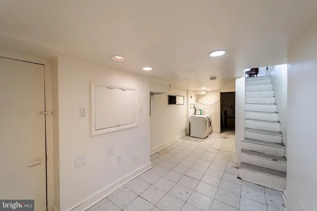 a view of kitchen with refrigerator and window