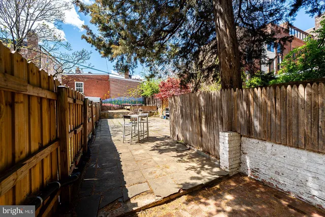 a view of a pathway with a wrought fence