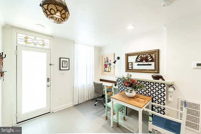 a room with furniture and paintings on the wall