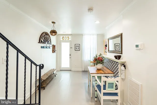 a dining room with wooden floor and stairs