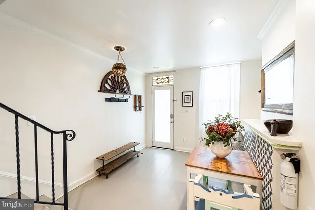 a living room with furniture and flowers