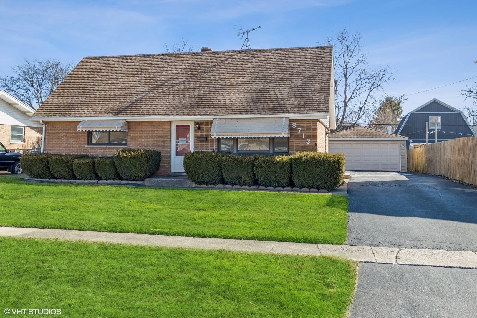 a front view of a house with a garden