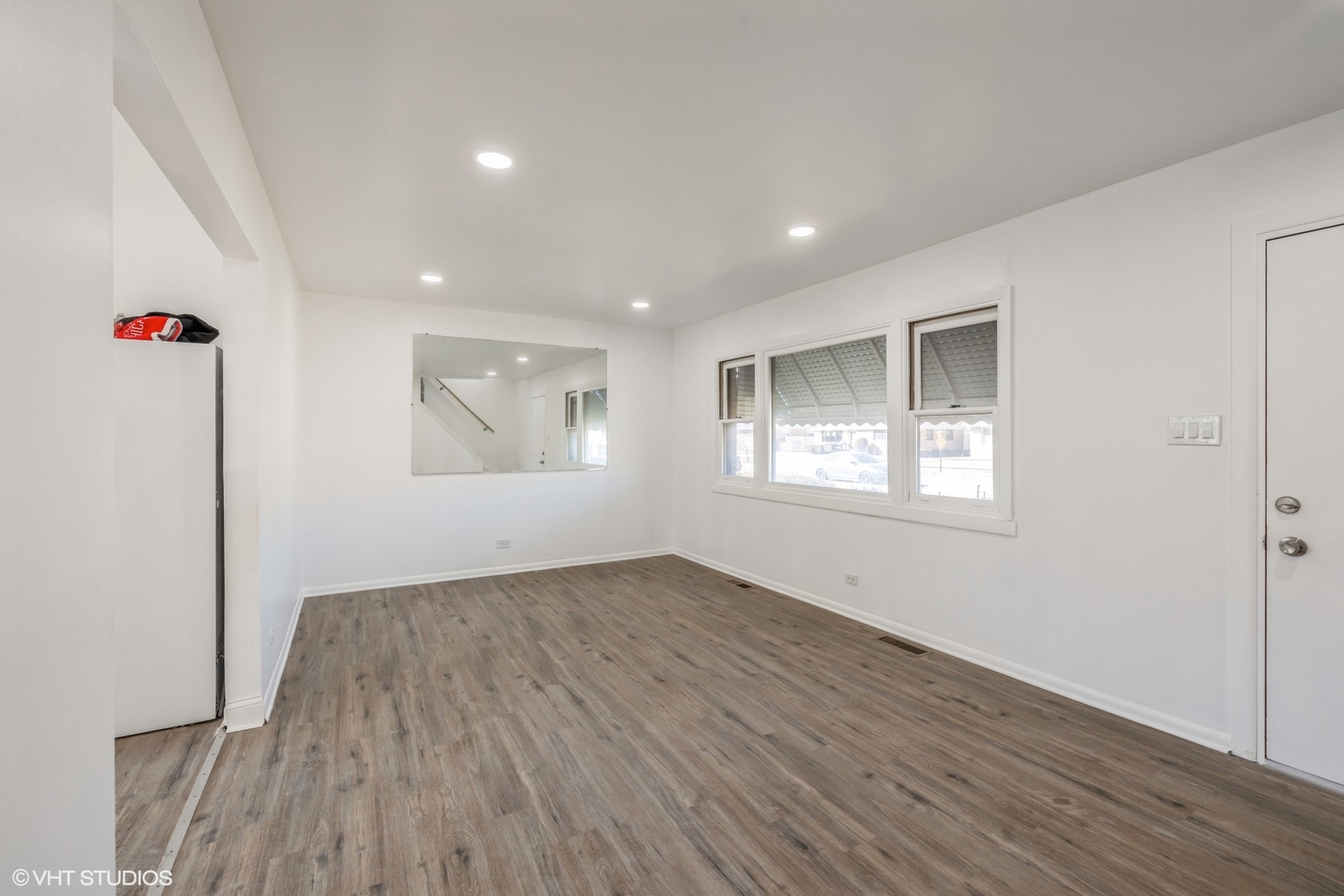 8713 Cranbrook Lane Bridgeview, IL 60455 - Photo 4 of 15 an empty room with wooden floor and windows