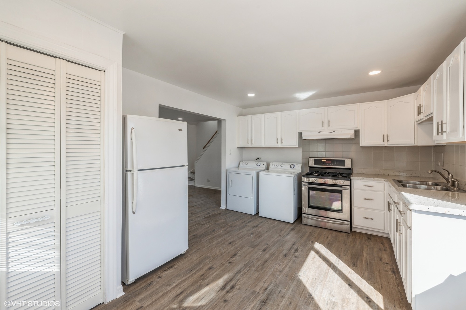 8713 Cranbrook Lane Bridgeview, IL 60455 - Photo 6 of 15 a kitchen with a refrigerator a stove top oven and wooden floor