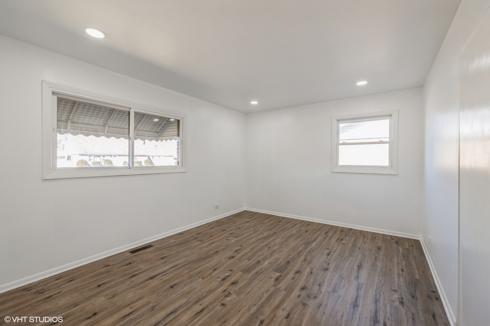 8713 Cranbrook Lane Bridgeview, IL 60455 - Photo 7 of 15 an empty room with wooden floor and windows