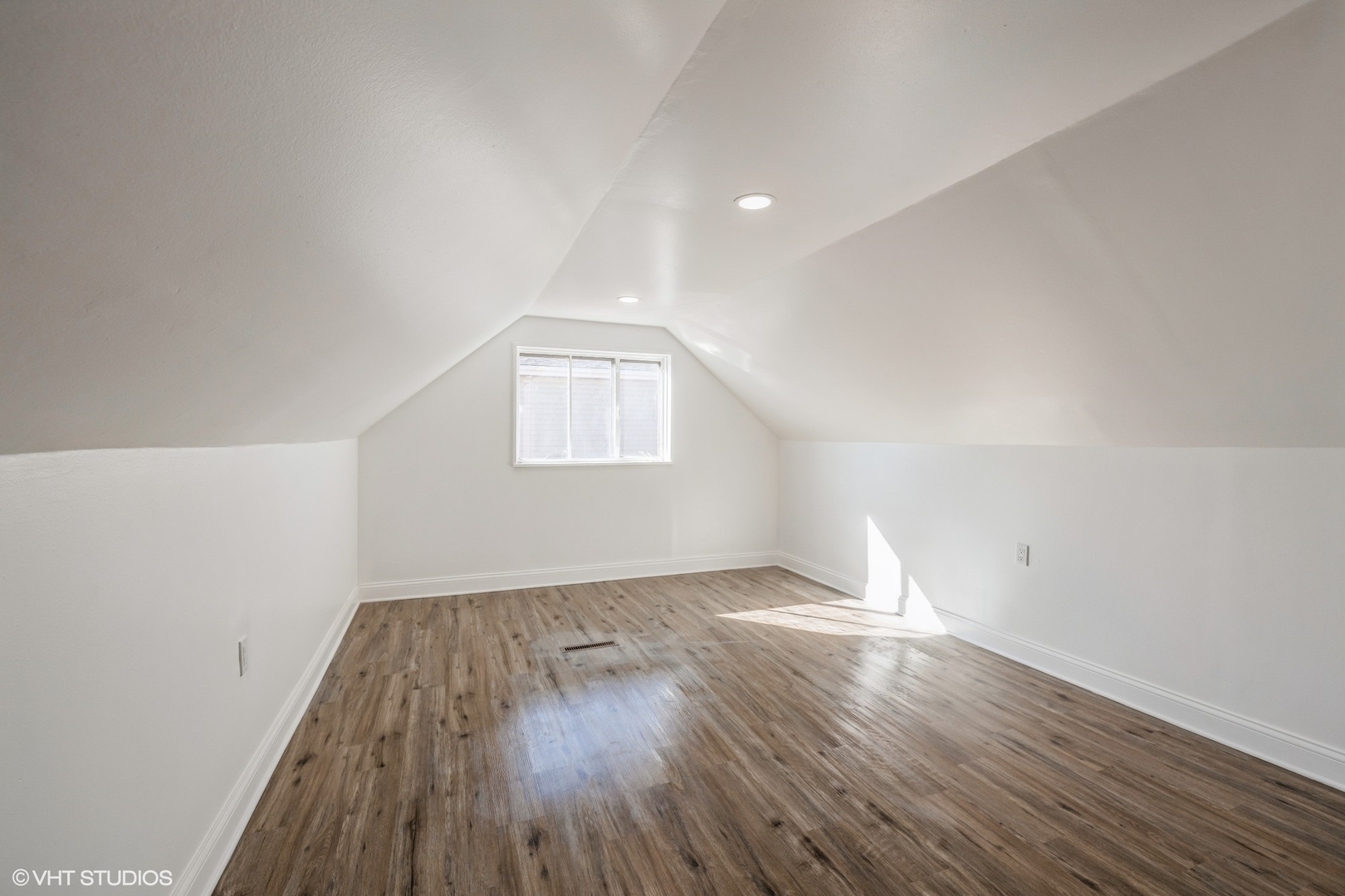 8713 Cranbrook Lane Bridgeview, IL 60455 - Photo 9 of 15 an empty room with wooden floor and windows