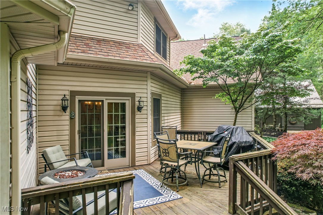 1681 State Road Northwest Warren, OH 44481 - Photo 10 of 50 Wooden terrace with outdoor dining space and a fire pit