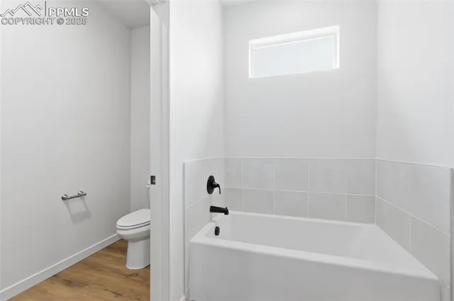 a white bath tub sitting next to a white toilet
