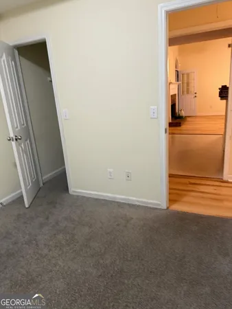 a view of a room with an empty space and a balcony