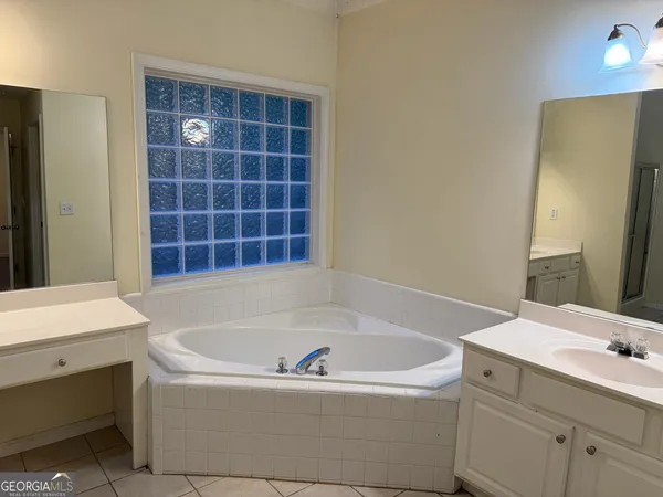a bathroom with a bathtub and a sink