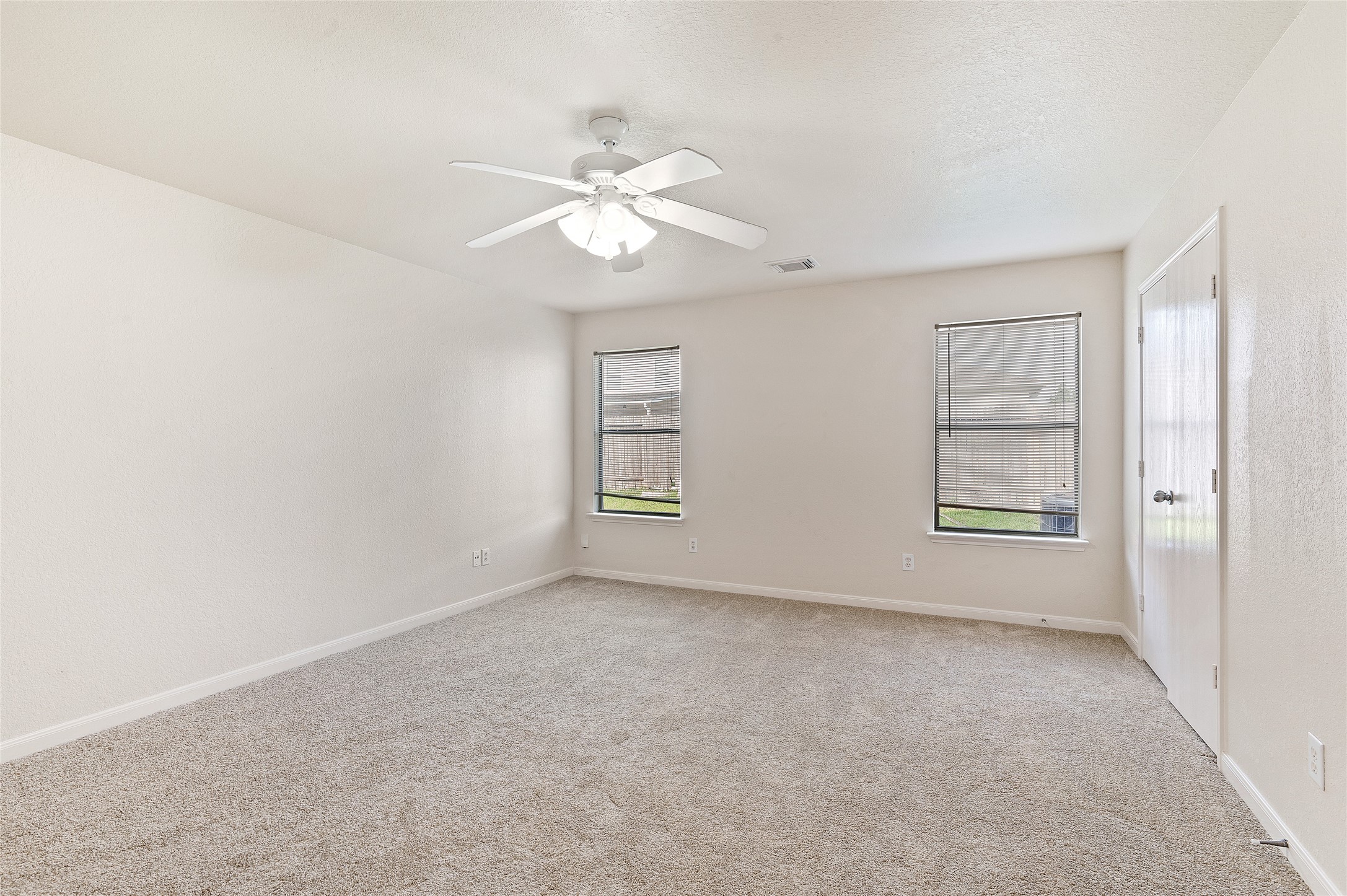 29522 Legends Stone Drive Spring, TX 77386 - Photo 12 of 17 an empty room with windows and fan