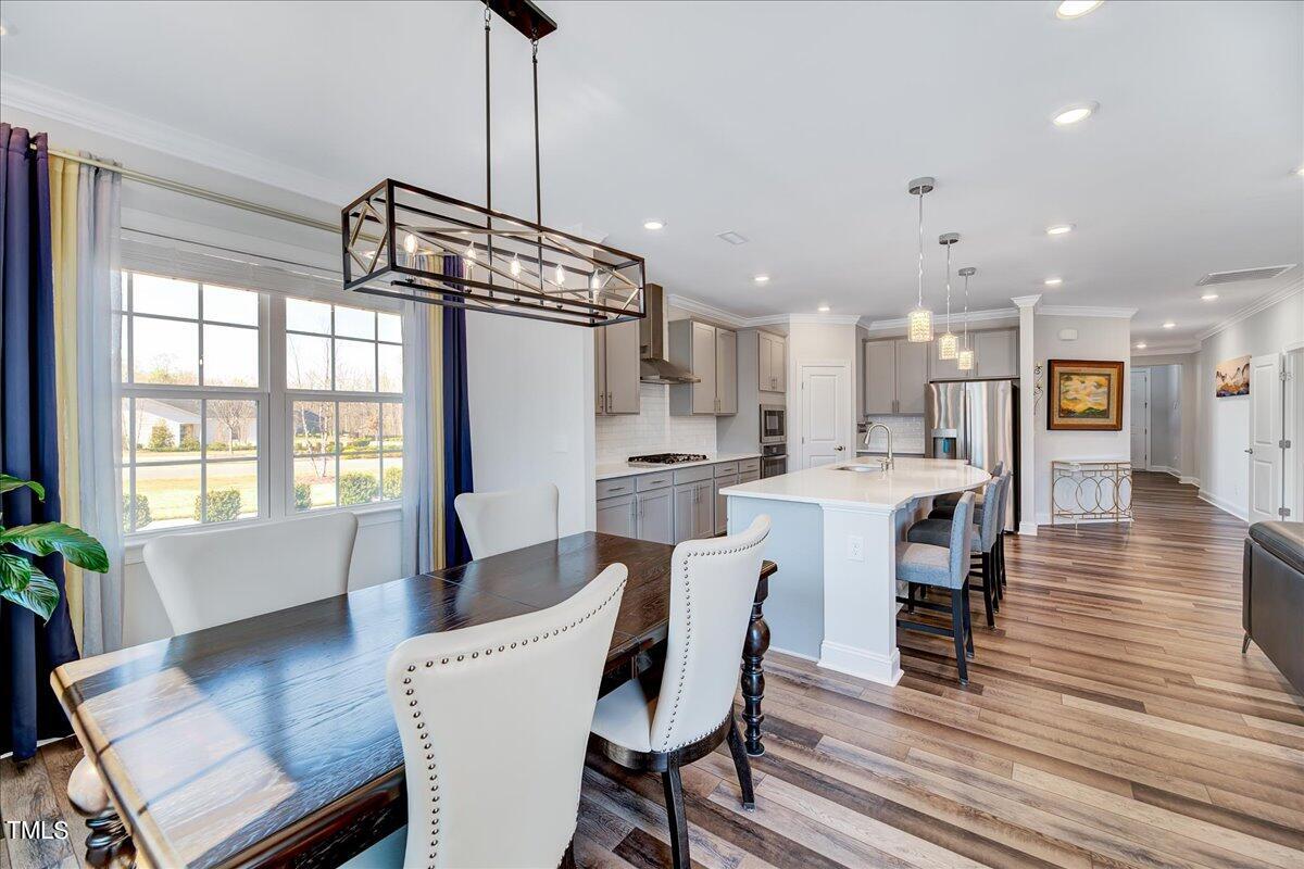 106 Mahogany Run Raleigh, NC 27610 - Photo 14 of 35 a view of a dining room with furniture window and wooden floor