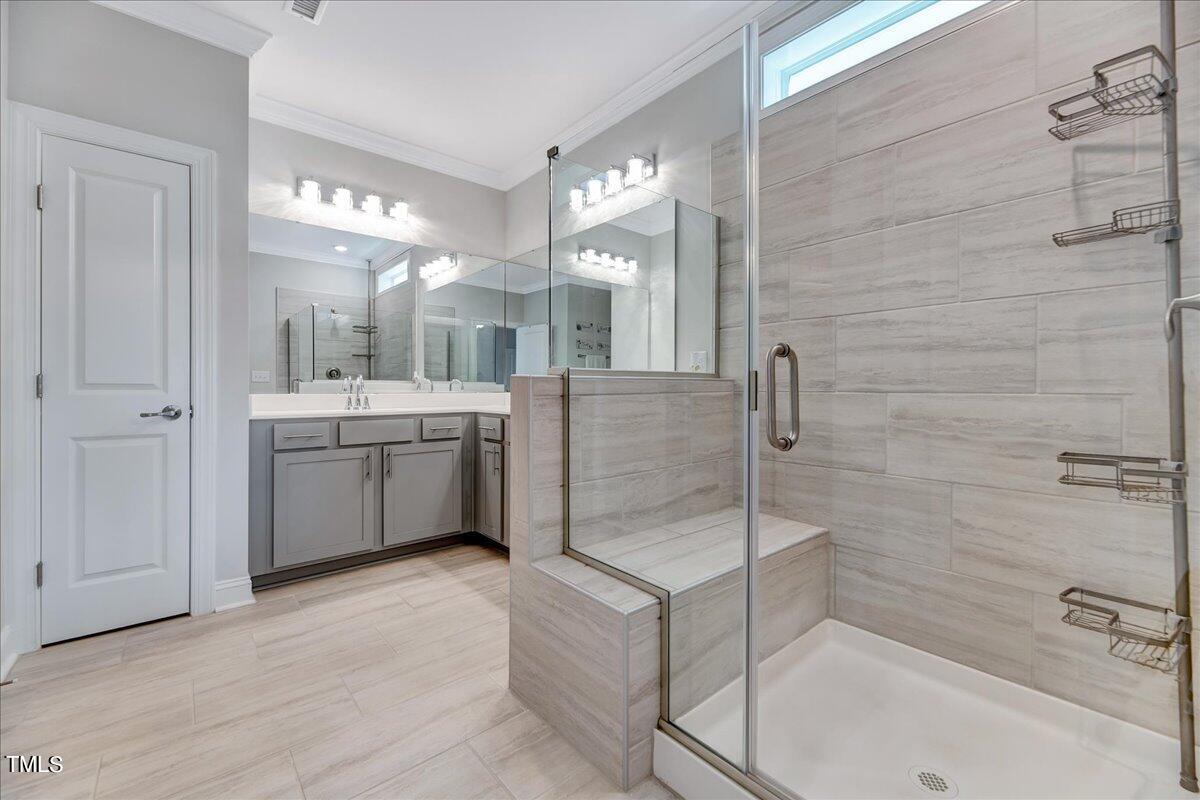 106 Mahogany Run Raleigh, NC 27610 - Photo 20 of 35 a bathroom with a double vanity sink a mirror and a bathtub