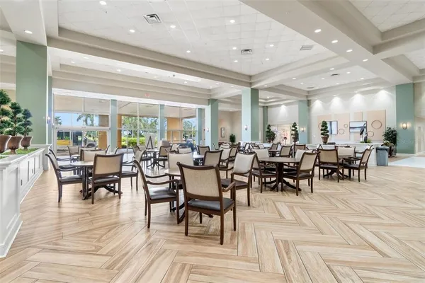 an outdoor space with lots of chairs and mirrors