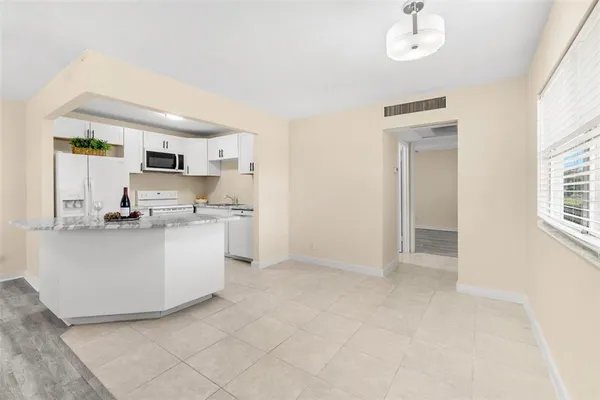 a living room with kitchen island furniture and kitchen view