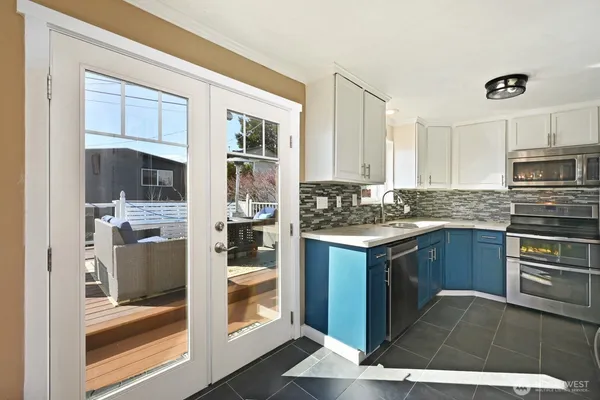 a kitchen with a refrigerator and a stove top oven