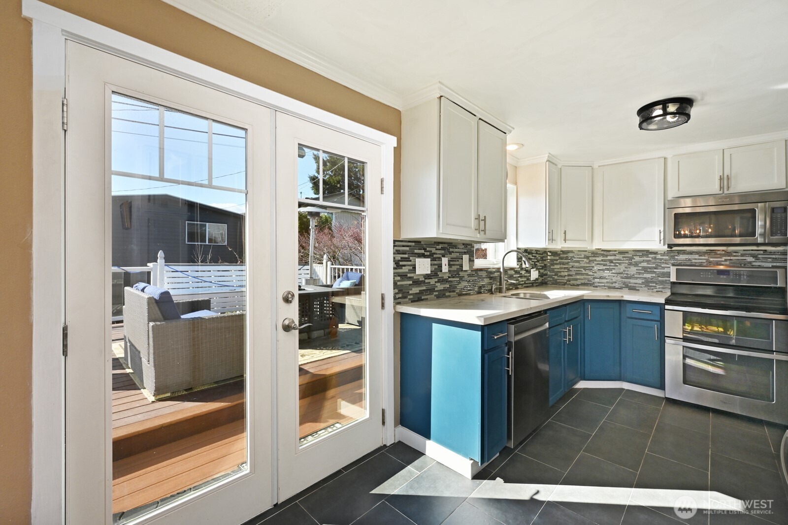8451 40th Avenue Southwest Seattle, WA 98136 - Photo 11 of 37 a kitchen with a refrigerator and a stove top oven