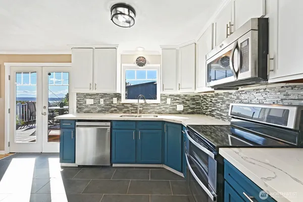 a kitchen with stainless steel appliances granite countertop a sink and a stove